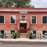 Union, OR 25 A brick building with a sign reading Public Library above the door, four large front windows, and a ramp leading to the entrance, surrounded by plants and trees.