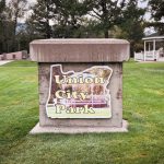 Union, OR 28 A concrete sign in a grassy park displays Union City Park with an outline of Oregon and a gazebo in the background. Trees and a white gazebo are visible on the lawn behind the sign.